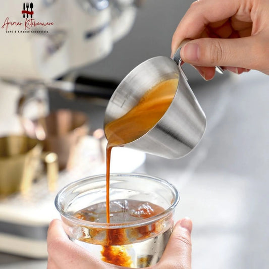 Stainless steel espresso measuring cup 100ml with handle and pouring spout showing internal volume markings