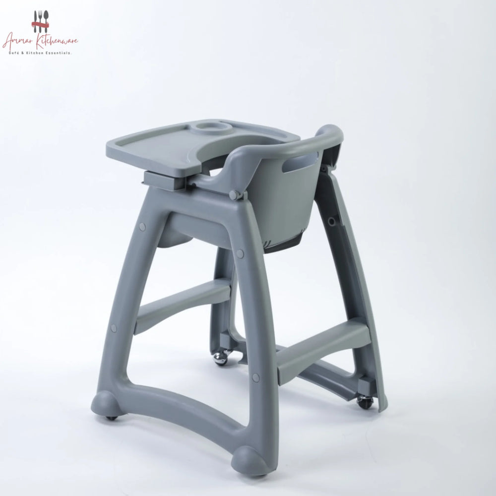 Commercial baby high chair with caster wheels, adjustable tray, and toddler dining in a restaurant