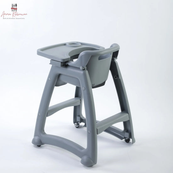 Commercial baby high chair with caster wheels, adjustable tray, and toddler dining in a restaurant