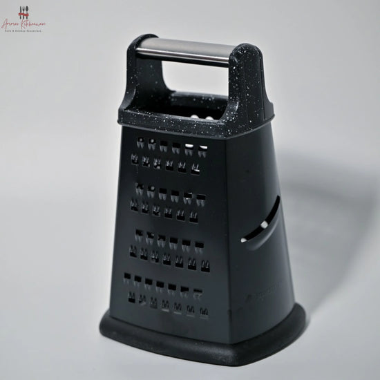 Black cheese grater on a gray background