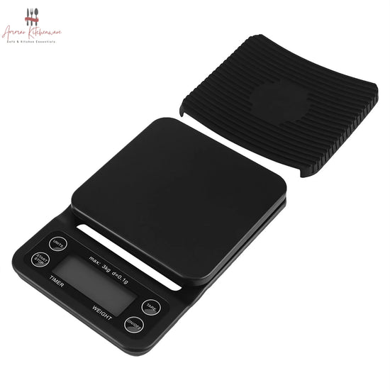 Black digital coffee scale with green dual backlit screen, integrated timer, and removable black silicone mat