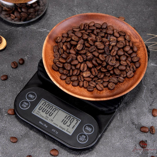 Black espresso digital coffee scale showing dual LCD display with timer and weight readout