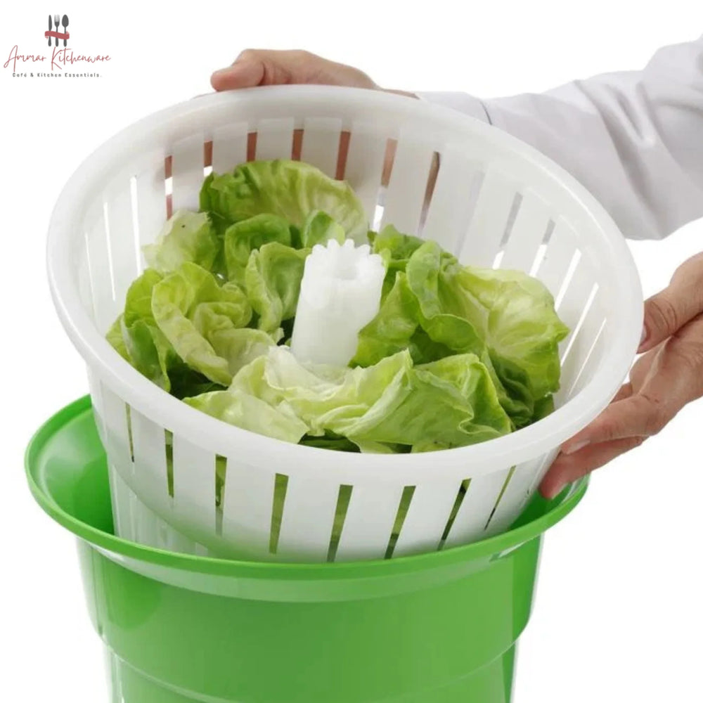 Commercial green salad spinner with metal hand crank arm and white inner colander basket